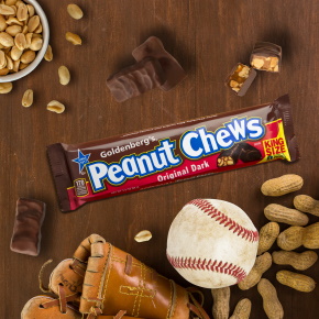 Goldenberg's Peanut Chews candy bar surrounded by baseball, glove and ingredients